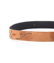The Upswing II by Bed|Stü is a brown leather belt with a black inner lining, featuring beautifully embossed floral and swirl designs, photographed against a white background. This handcrafted accessory offers intricate artistry, making it a standout floral design belt for any wardrobe.