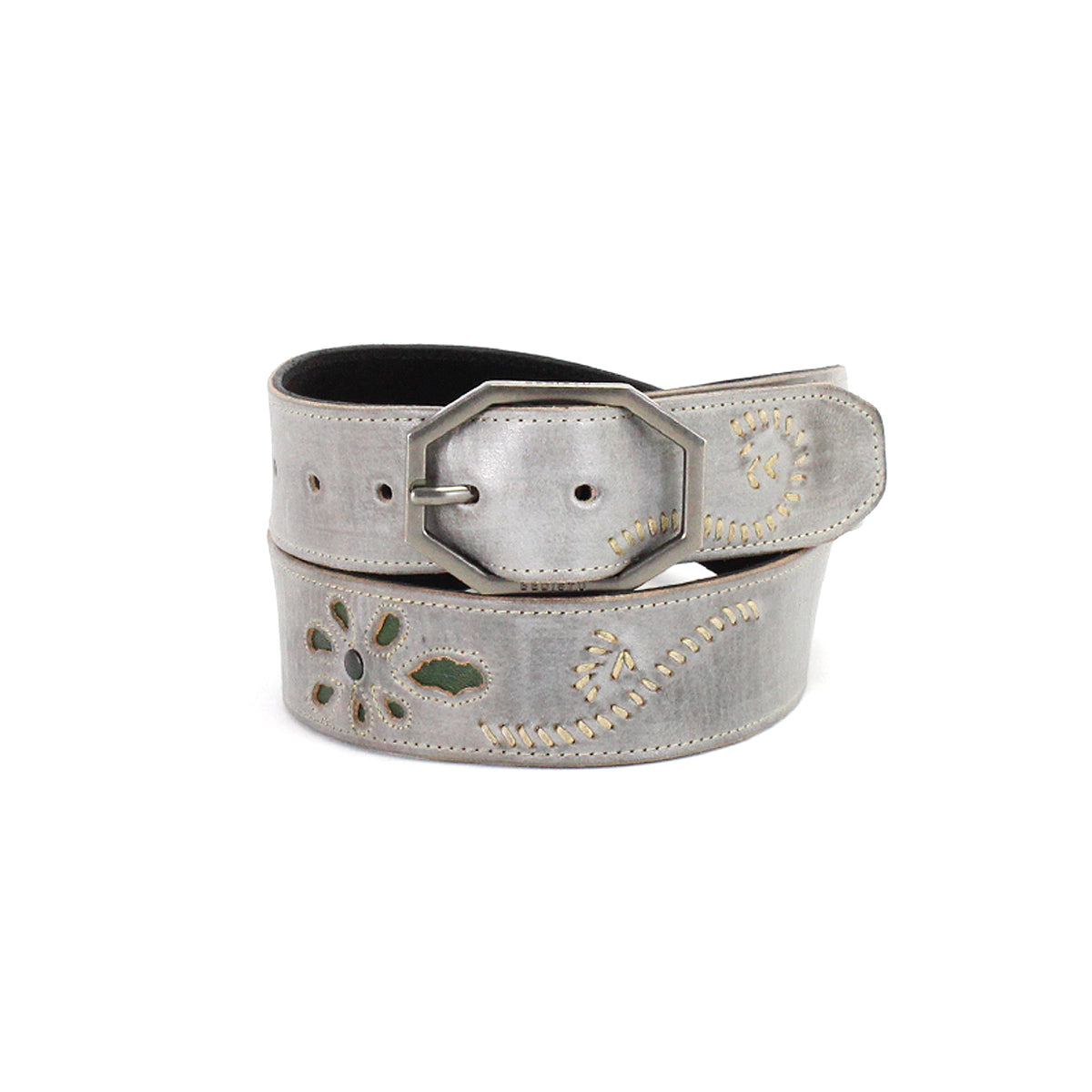The Bed|Stü Upswing II is a handcrafted leather belt featuring decorative cutout patterns, contrast stitching, and a metal buckle, elegantly coiled against a white background. This artisanal accessory showcases subtle gray tones and intricate detailing for a sophisticated finishing touch.