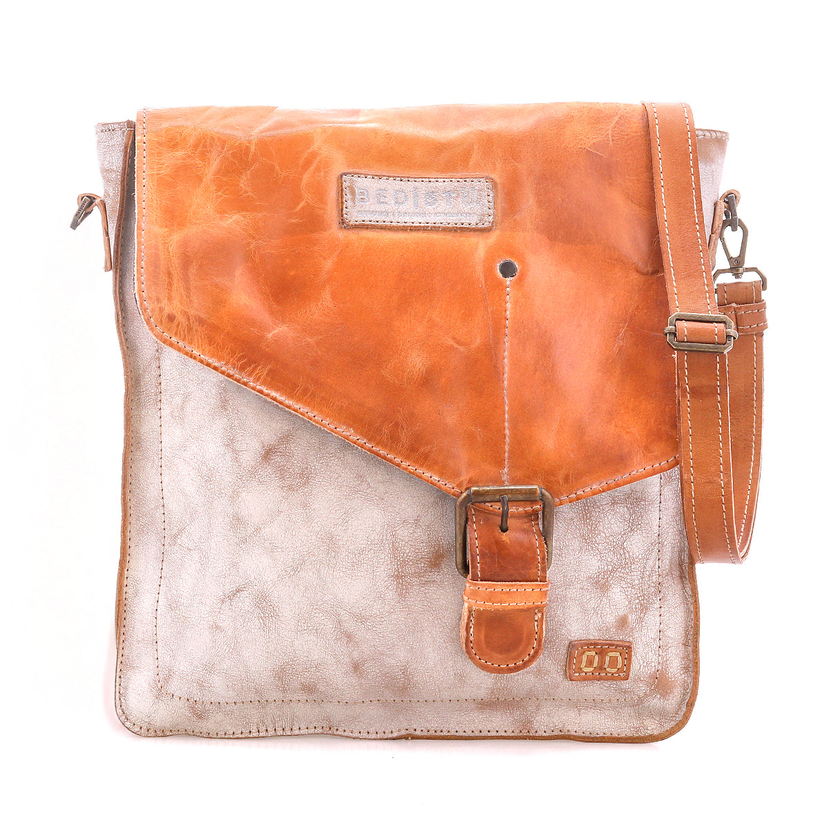 Introducing the Venice Beach crossbody bag by Bed|Stü, crafted from full-grain leather with a striking two-tone design. This piece features a tan flap, prominent buckle closure, adjustable strap, and visible stitching, beautifully photographed against a white background.