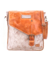Introducing the Venice Beach crossbody bag by Bed|Stü, crafted from full-grain leather with a striking two-tone design. This piece features a tan flap, prominent buckle closure, adjustable strap, and visible stitching, beautifully photographed against a white background.