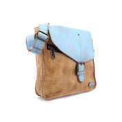 Bed|Stü Venice Beach crossbody bag in light blue and tan full-grain leather, featuring a front pocket, buckle closure, and an adjustable strap, displayed on a white background.