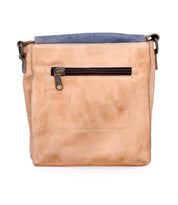 The Bed|Stü Venice Beach is a tan crossbody bag crafted from full-grain leather, featuring a blue top trim, front zippered pocket, and an adjustable strap, displayed against a white background.