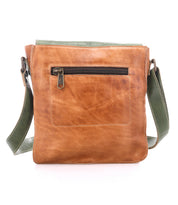 The Bed|Stü Venice Beach crossbody bag, crafted from brown full-grain leather, features a green adjustable strap and a front zippered pocket, shown upright against a white background.
