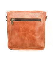 The Venice Beach by Bed|Stü is a square, tan full-grain leather crossbody bag with visible stitching and a front zippered pocket. It features an adjustable strap and is displayed against a plain white background.