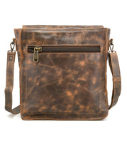 Introducing the Venice Beach crossbody bag by Bed|Stü—a brown full-grain leather bag featuring a front zipper pocket and an adjustable strap, showcased against a white background.
