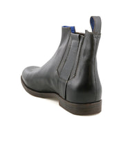 The Bed|Stü Verrocchio, a handcrafted leather Chelsea boot featuring elastic side panels and a low heel for everyday wear, is displayed from the back angle against a white background.