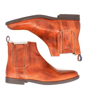 Introducing Verrocchio by Bed|Stü: a pair of tan handcrafted leather Chelsea boots featuring elastic side panels, pull tabs, and dark brown rubber soles, showcased from both side and sole views on a white background—perfect for everyday wear.