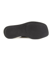 Black rubber sole of the Bed|Stü Vext shoe, featuring a rounded heel and toe with a leather-wrapped edge, shown from the bottom against a white background.
