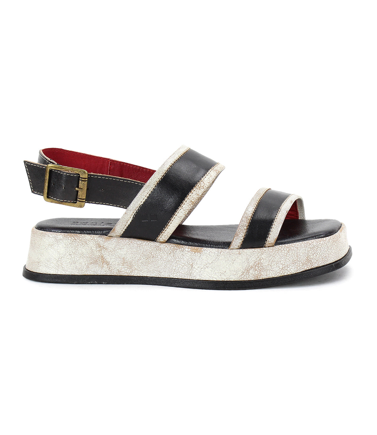 The Vice sandal by Bed|Stü is shown in a side profile view, featuring a black platform design with two straps, a gold buckle, and a thick, textured white sole. Its adjustable ankle strap offers added comfort and support.