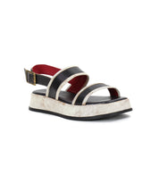 Introducing the Vice sandal by Bed|Stü—crafted with black leather straps, a metallic adjustable buckle at the ankle, a thick white textured sole, and a touch of red on the inner lining.