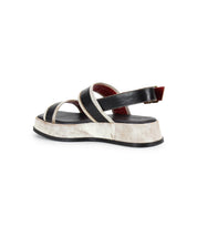 The Bed|Stü Vice sandal is showcased in profile on a white background, featuring black and white coloring, two front straps, an adjustable ankle strap, and a slightly elevated platform sole.