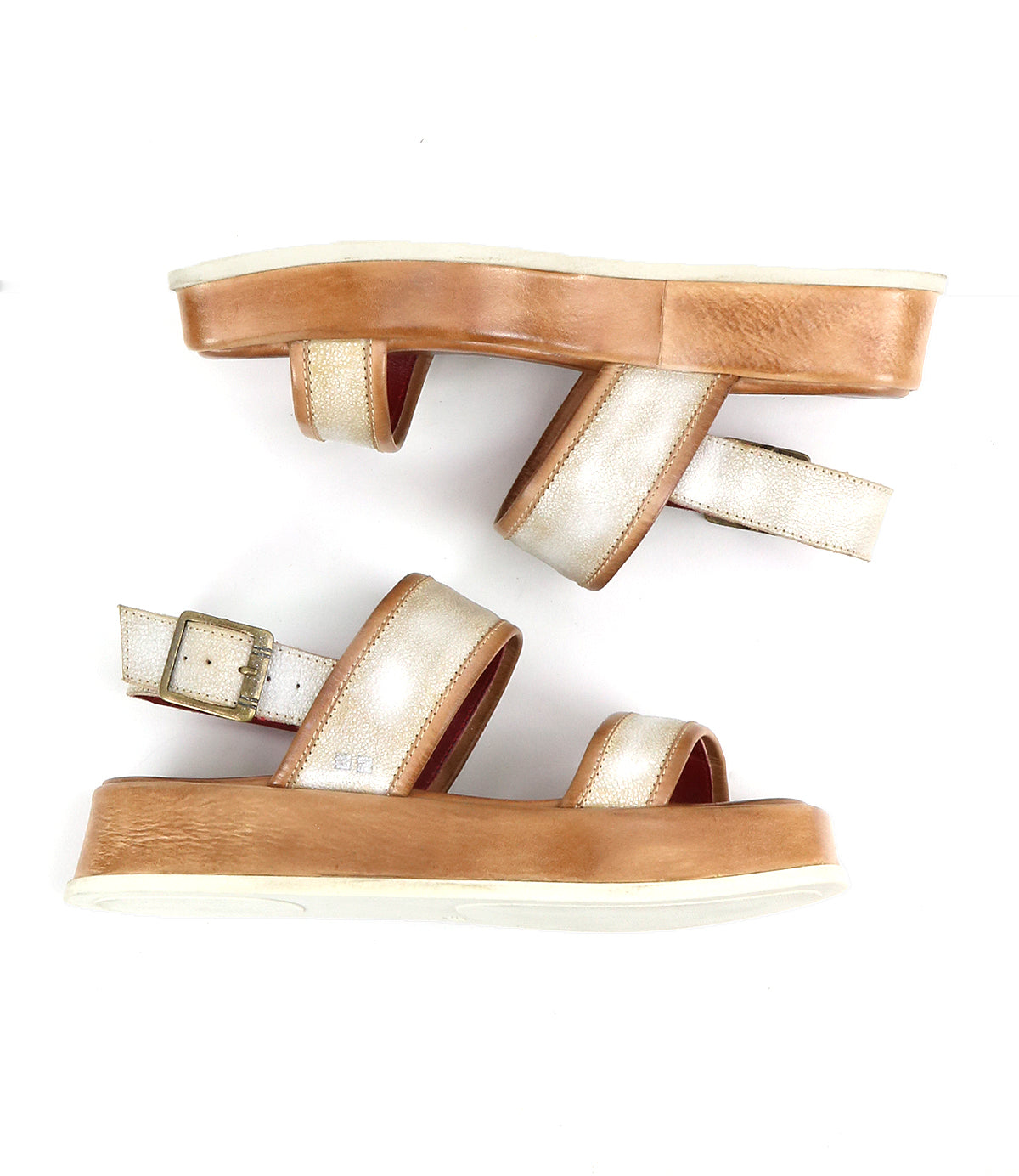 A side view of the Bed|Stü Vice sandals is shown on a white background, featuring strappy metallic gold straps, tan platform soles, and an adjustable ankle strap.