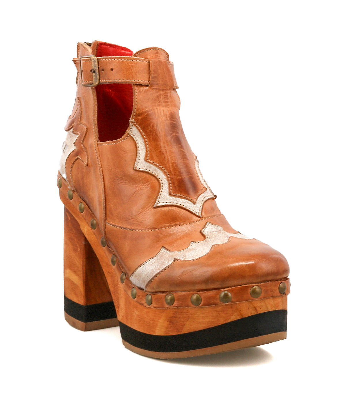 The Viretta by Bed|Stü is a tan leather platform boot featuring decorative stitching, a handcrafted wooden platform, metal studs around the sole, a block heel, side buckle, and striking red interior lining—a vintage-inspired shoe that seamlessly blends classic design with modern flair.