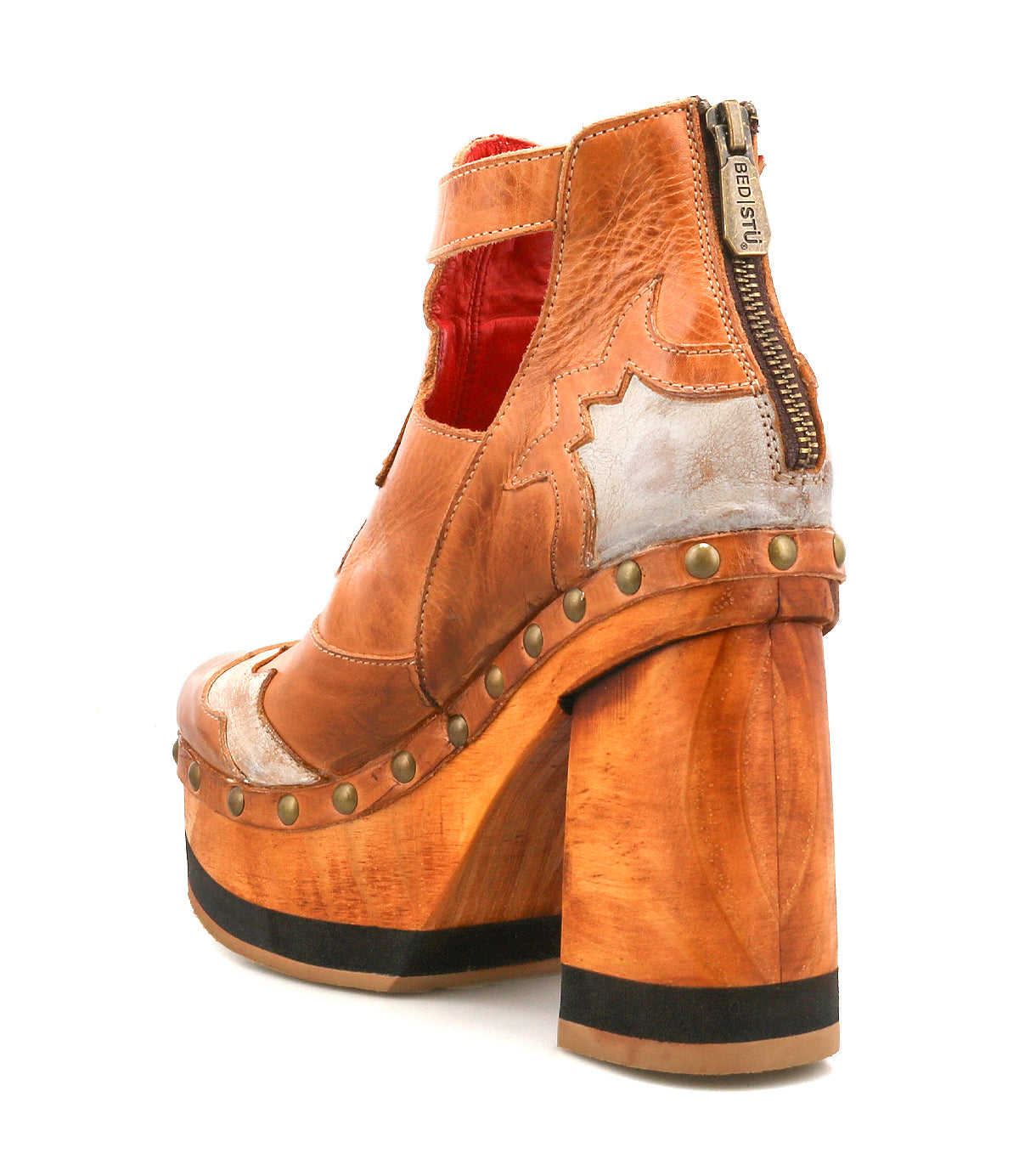 The Viretta by Bed|Stü is a brown leather platform shoe featuring a handcrafted wooden platform, metallic accents, brass studs, rear zipper, and cut-out sides, shown from the back left angle—embodying a true vintage-inspired style.