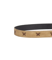The Wander belt by Bed|Stü features tan leather with evenly spaced brown butterfly designs, shown partially against a white background—an effortlessly whimsical accessory for any outfit.