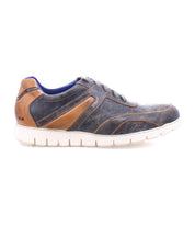 The Bed|Stü Wardell is a casual men's lace-up sneaker featuring a layered leather upper in dark blue and brown hues and a white cushioned sole, shown from the side against a white background.