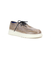 The Bed|Stü Webmaster is a brown leather lace-up shoe with a thick white sole, showcasing a comfortable moc-toe sneaker design, photographed against a plain white background.
