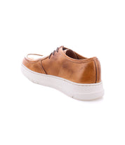 Bed|Stü Webmaster brown leather moc-toe sneaker featuring a lace-up design and a white rubber sole, shown from the back left on a white background.