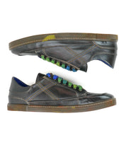 Two brown low-profile Wizard leather sneakers by Bed|Stü, featuring an all-leather construction with crossover stitching and multicolored green and blue laces, are shown from the side on a white background.