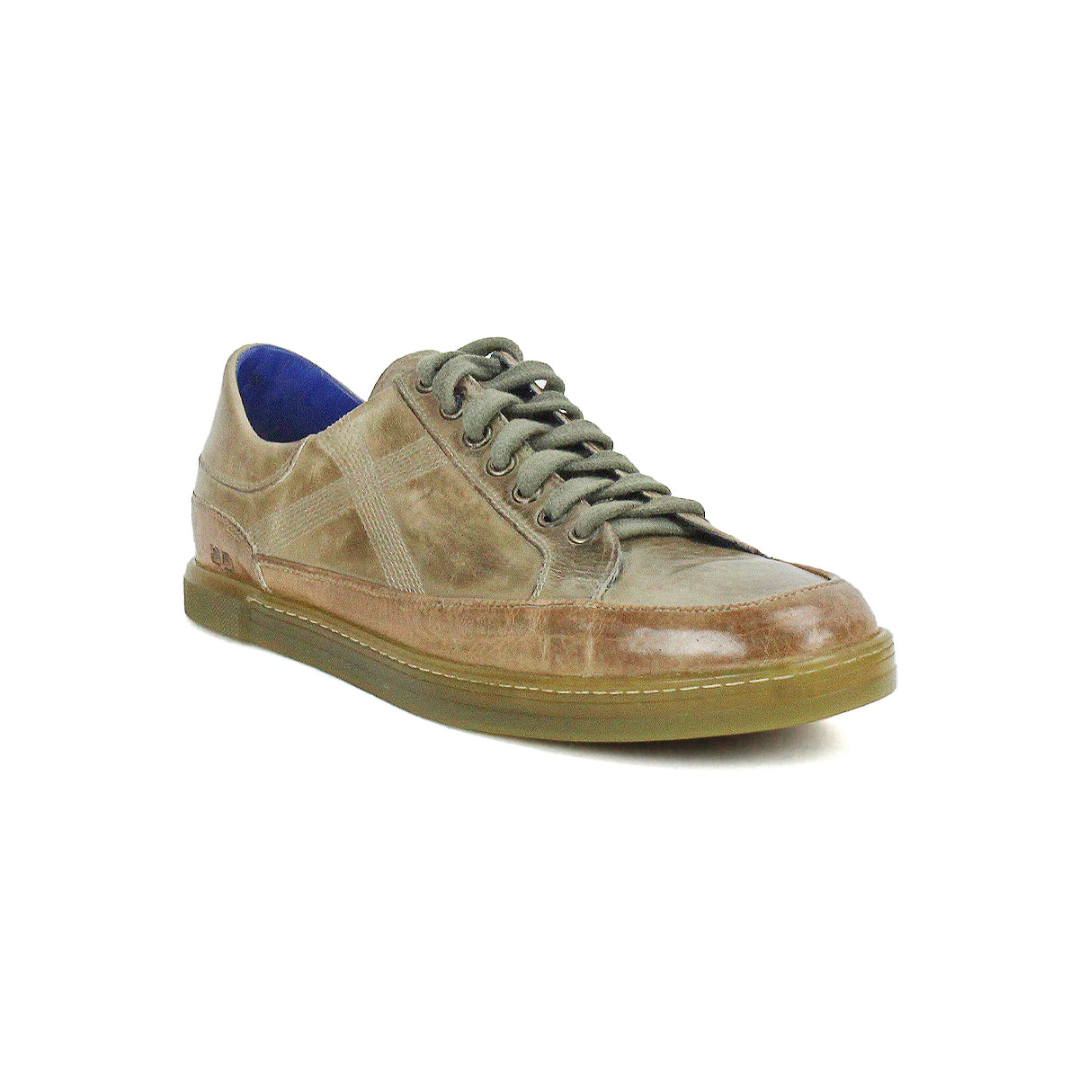 Introducing the Bed|Stü Wizard: a brown, low-profile leather sneaker with greenish laces, signature crossover side stitching, a blue inner lining, and a translucent rubber sole—all showcased against a white background.