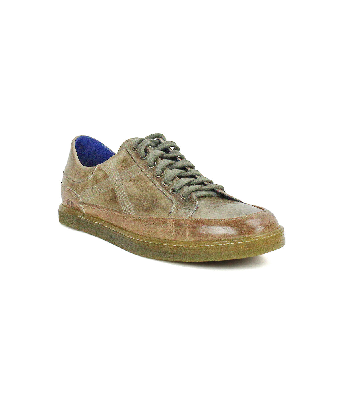 Introducing the Bed|Stü Wizard: a brown, low-profile leather sneaker with greenish laces, signature crossover side stitching, a blue inner lining, and a translucent rubber sole—all showcased against a white background.