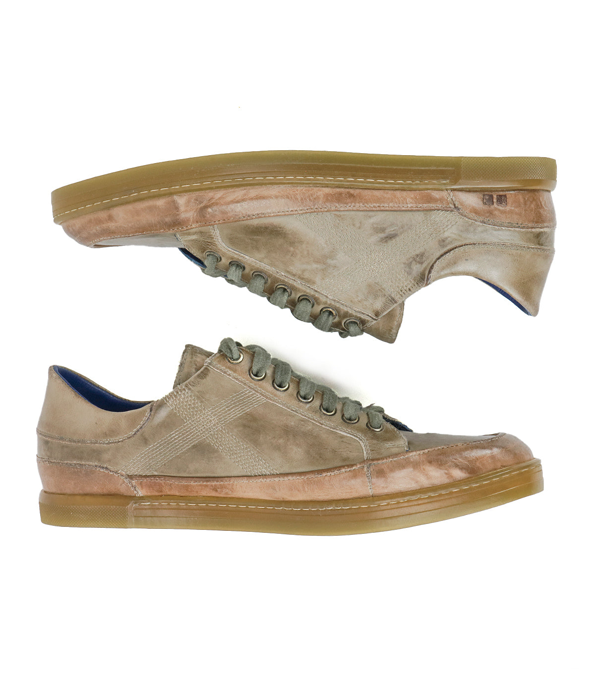 A pair of Bed|Stü Wizard low-top sneakers in tan and brown are displayed side by side on a white background, featuring green laces, gum rubber soles, an all-leather construction, and subtle crossover stitching for added detail.
