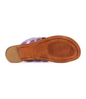 The image shows the bottom view of a single Yoli sandal by Bed|Stü, featuring a tan leather sole with textured grip lines near the front. This leather thong sandal blends style and functionality, delivering both durability and comfort.