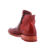 The Yurisa ankle boot by Bed|Stü, shown from the back angle on a white background, showcases red leather construction with a side zipper, stacked heel, and a durable leather outsole.