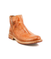 The Yurisa by Bed|Stü is a light brown leather ankle boot featuring a low heel, handcrafted detailing, visible stitching, and a durable leather outsole, shown against a white background.