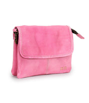 The Ziggy by Bed|Stü is a small, rectangular pink crossbody bag crafted from supple leather, featuring a front flap with two small gold square accents in the bottom right corner.