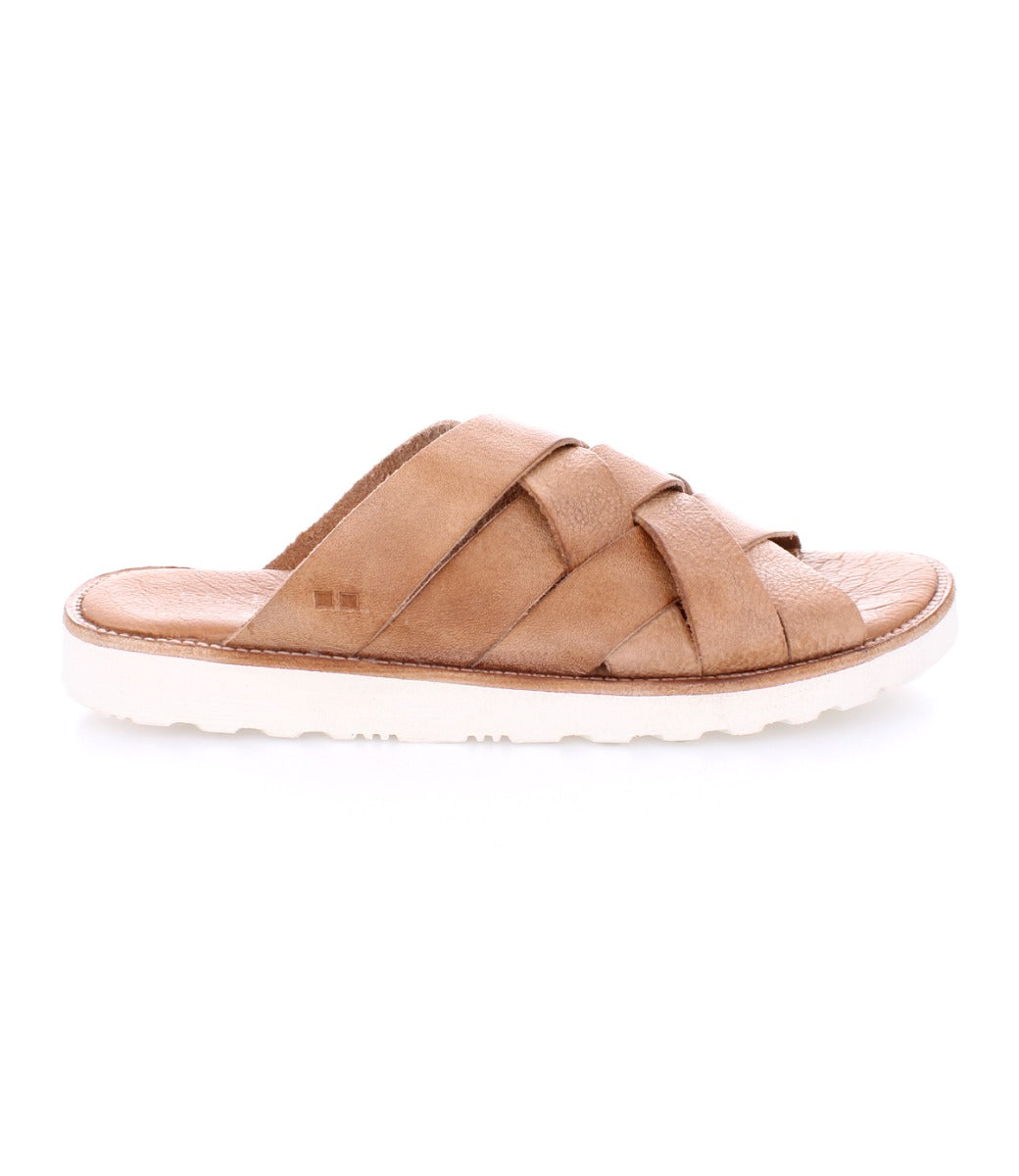 The Bed|Stü Abraham Light is a tan slide sandal featuring a woven leather upper with crisscross straps and a white, textured, lightweight outsole designed for all-day comfort, shown from the side against a plain white background.