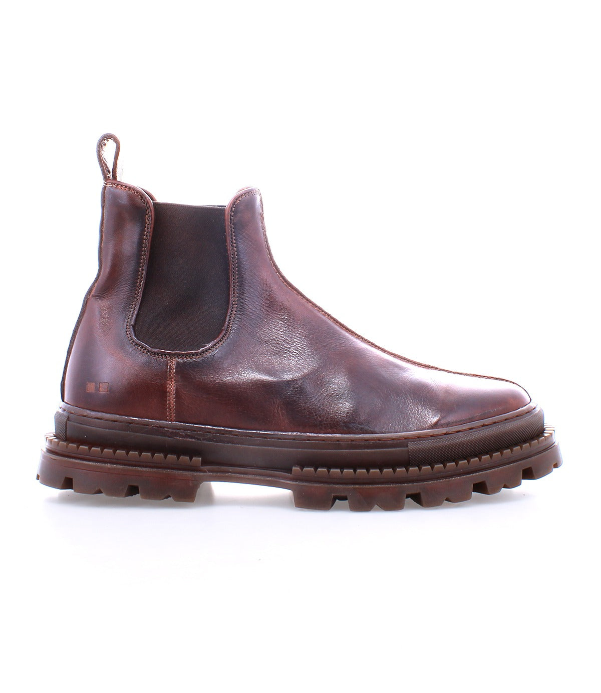 The Bed|Stü Accelerate is a brown leather Chelsea boot featuring elastic side panels, a pull tab, and a thick, rugged lug outsole that adds a modern edge to its classic silhouette, shown on a white background.