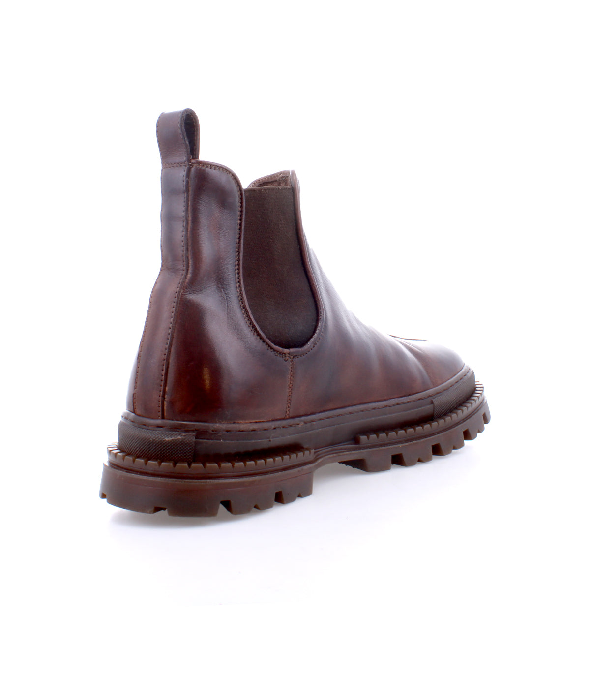 Meet Accelerate by Bed|Stü: a brown leather Chelsea boot featuring black elastic side panels and a thick, ridged lug outsole, pictured from the back and side on a white background—classic style reimagined with a contemporary edge.