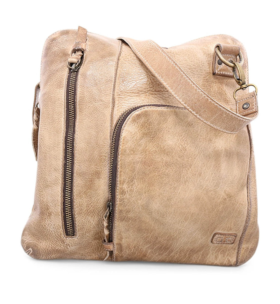The Bed|Stü Aiken crossbody bag, crafted from light brown full-grain leather, features a front zipper pocket, a vertical side zipper, anti-theft security details, an adjustable strap, and metal hardware—pictured here against a white background.