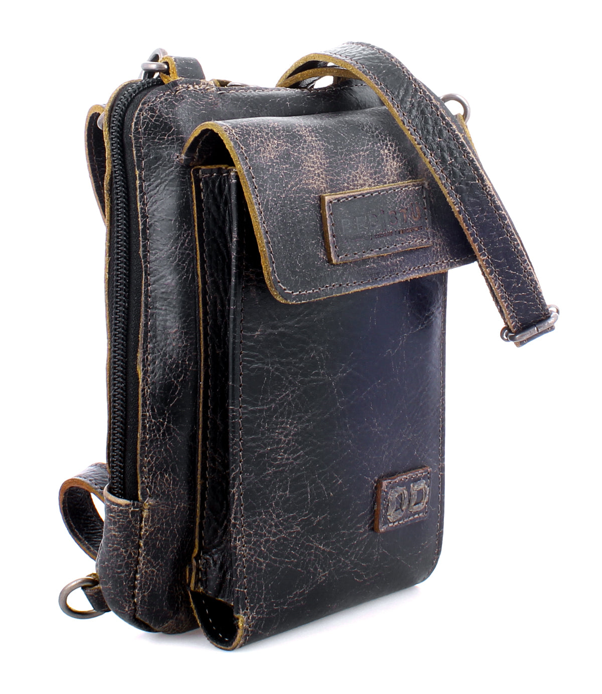 The Bed|Stü Alelike is a small, dark brown weathered leather crossbody bag featuring a front flap, zipper compartment, and adjustable strap—an ideal compact purse for keeping your travel essentials organized and close at hand.