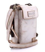 The Bed|Stü Alelike is a light beige leather crossbody bag featuring a front flap, zipper compartment, and a signature “Bed|Stü” logo patch—this compact purse is perfect for keeping your travel essentials organized and within easy reach.