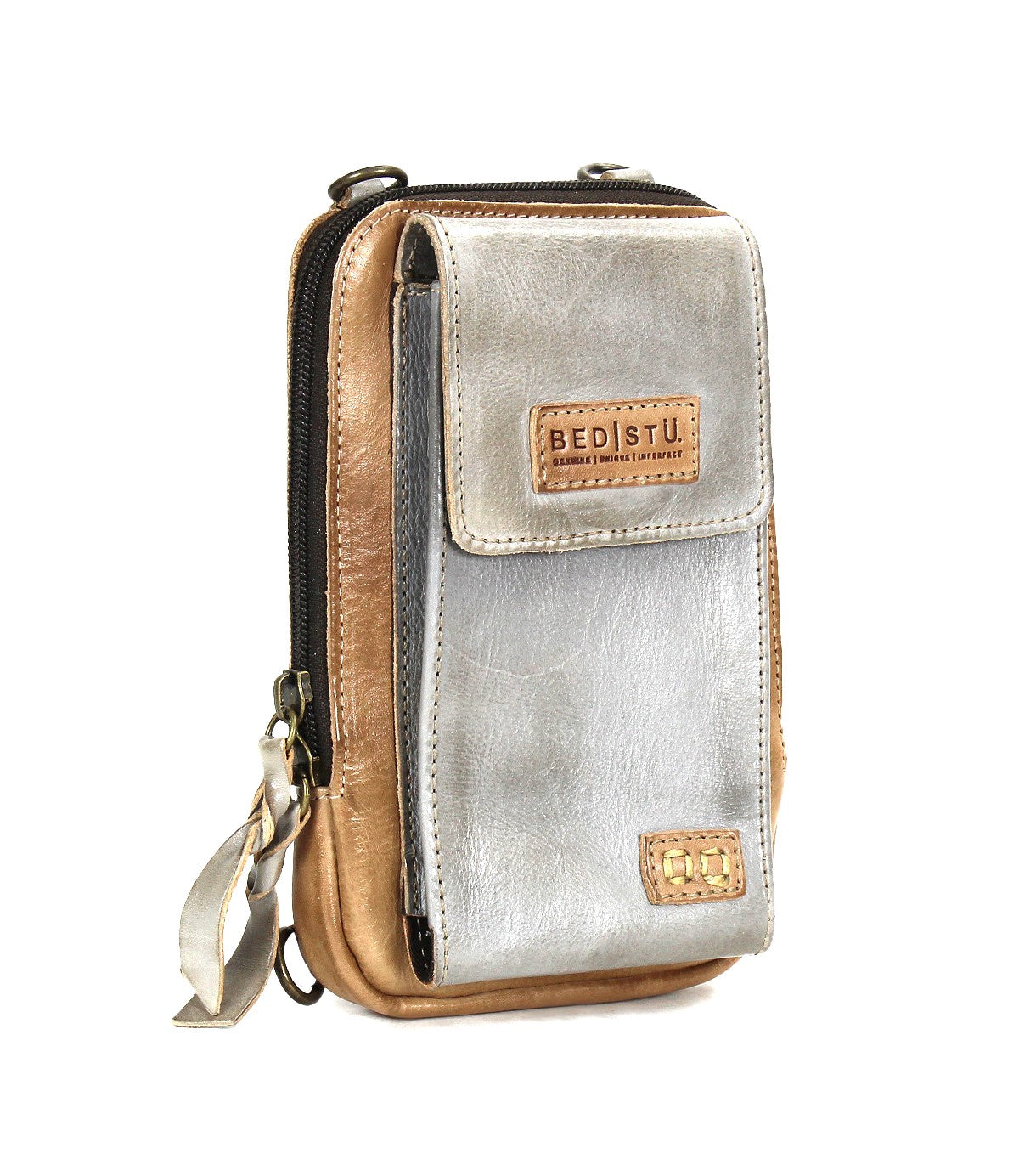 The Alelike by Bed|Stü is a small two-tone leather crossbody bag featuring a front pocket, zipper closure, and a signature Bed|Stü logo patch on the front flap—perfect for carrying your travel essentials in style.