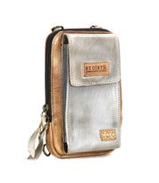 The Alelike by Bed|Stü is a small two-tone leather crossbody bag featuring a front pocket, zipper closure, and a signature Bed|Stü logo patch on the front flap—perfect for carrying your travel essentials in style.