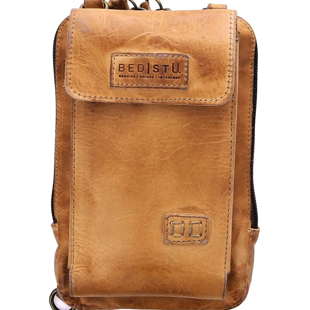 Introducing the Alelike by Bed|Stü—a compact crossbody bag crafted from tan leather, featuring a convenient front flap pocket, secure zipper top, and a distinctive "Bed|Stü" logo patch on the front. Perfect for carrying your travel essentials with ease and style.