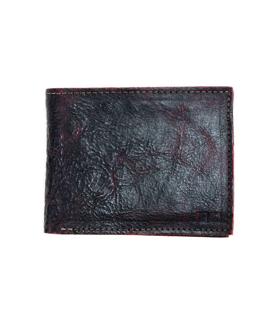 The Bed|Stü Amidala is a closed, dark brown bifold wallet featuring visible stitching and a slightly worn texture, photographed against a white background.