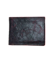 The Bed|Stü Amidala is a closed, dark brown bifold wallet featuring visible stitching and a slightly worn texture, photographed against a white background.