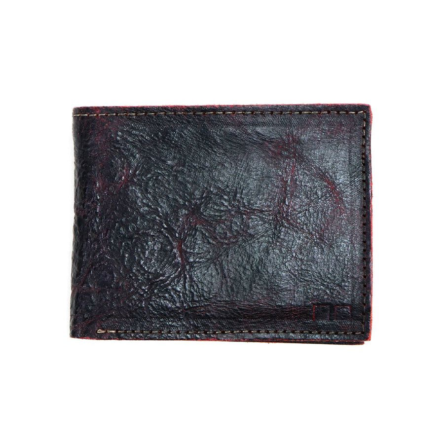 The Bed|Stü Amidala is a closed, dark brown bifold wallet featuring visible stitching and a slightly worn texture, photographed against a white background.