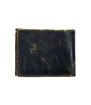 The Bed|Stü Amidala is a black leather bifold wallet featuring visible yellowish scuffs and stitching, shown closed against a white background.