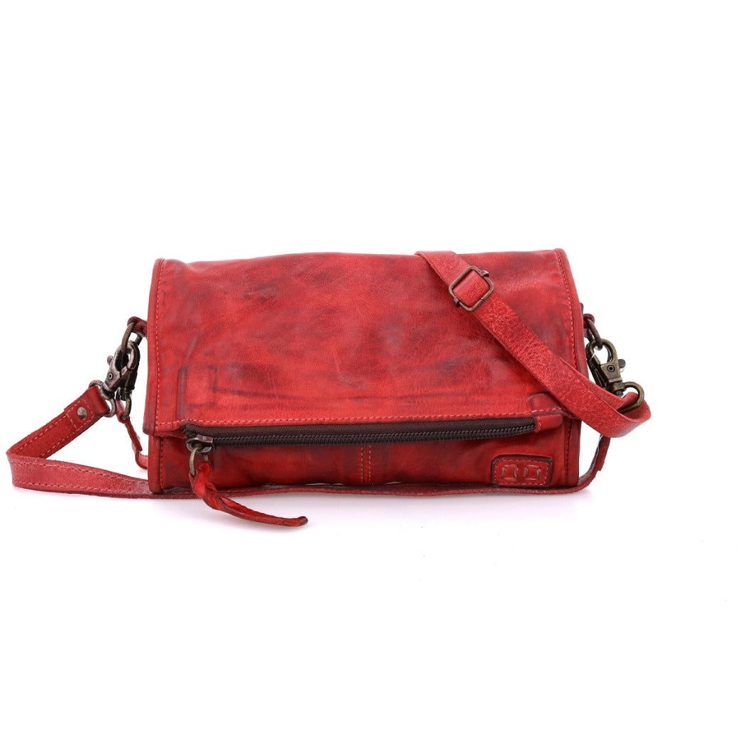 The Bed|Stü Amina is a red leather crossbody bag featuring a front zipper pocket, adjustable strap, and metal hardware—ideal for everyday use or pairing with your favorite wallet or clutch—shown here against a white background.