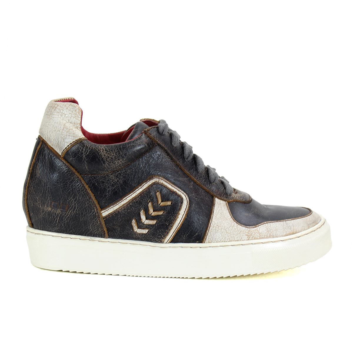 The Bed|Stü Andromeda is a city-ready leather sneaker in black, white, and brown, featuring a white sole and signature chevron design on the side, shown here in a left side profile.