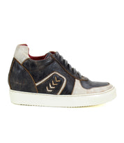 The Bed|Stü Andromeda is a city-ready leather sneaker in black, white, and brown, featuring a white sole and signature chevron design on the side, shown here in a left side profile.