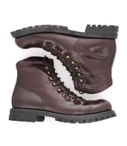 Two brown "Barge" boots by Bed|Stü, crafted from rugged leather with black, heavy-duty soles and sturdy lace-up detailing, are stacked sideways against a white background.