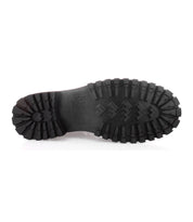 Close-up of the bottom of a Barge boot sole by Bed|Stü, featuring deep tread patterns and embossed text on black rubber, displayed against a white background—highlighting the durability and distinctive design of these rugged leather boots.