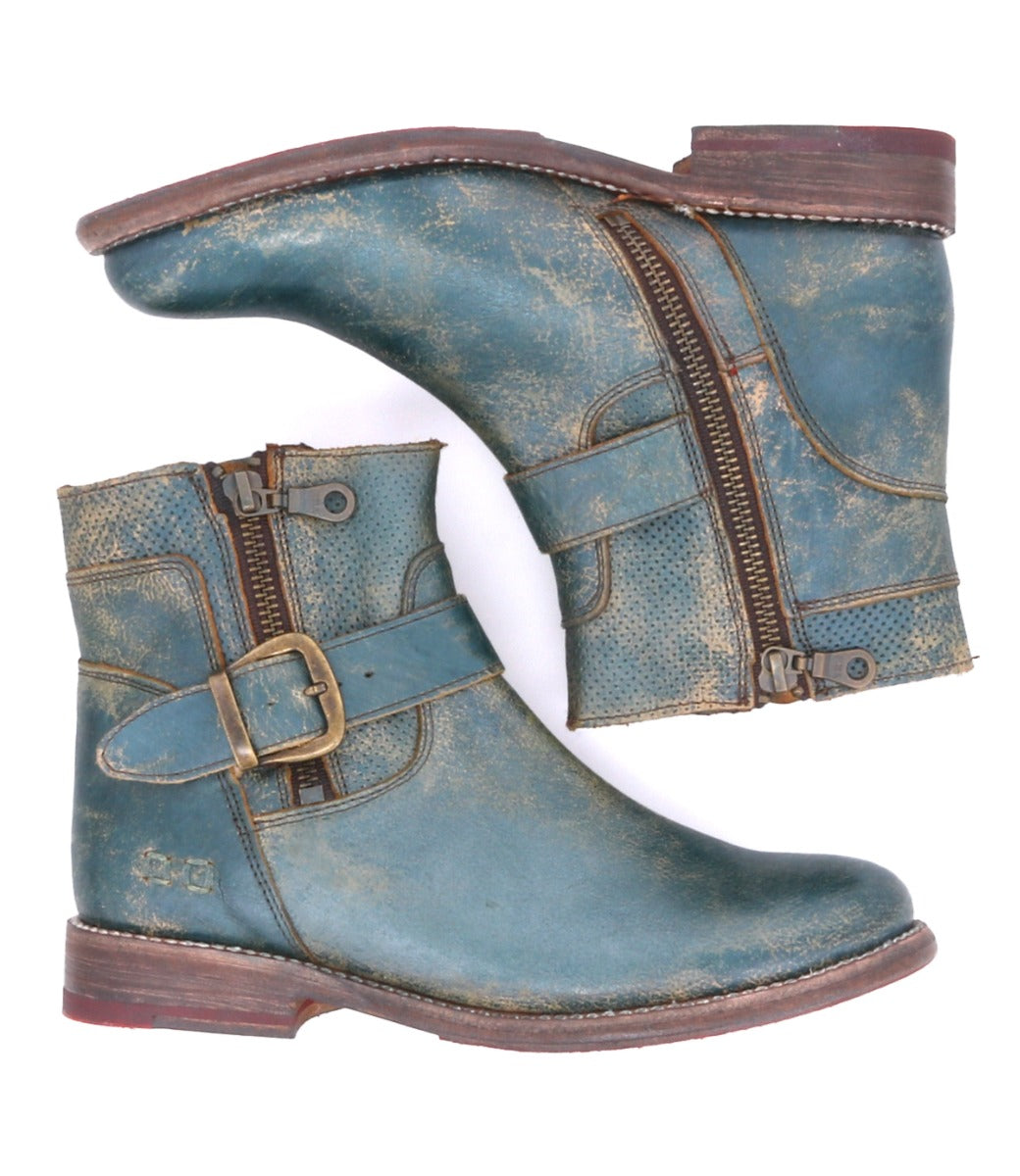 A pair of Becca distressed blue leather ankle boots by Bed|Stü, featuring a sturdy leather shaft, side zippers, ankle buckles, and low heels, displayed against a white background.