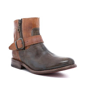Introducing the Becca by Bed|Stü—a leather ankle boot featuring a sturdy leather shaft, convenient side zipper, brown strap with ankle buckle, and a vintage-inspired two-tone finish in brown and gray for that classic engineer boot style.